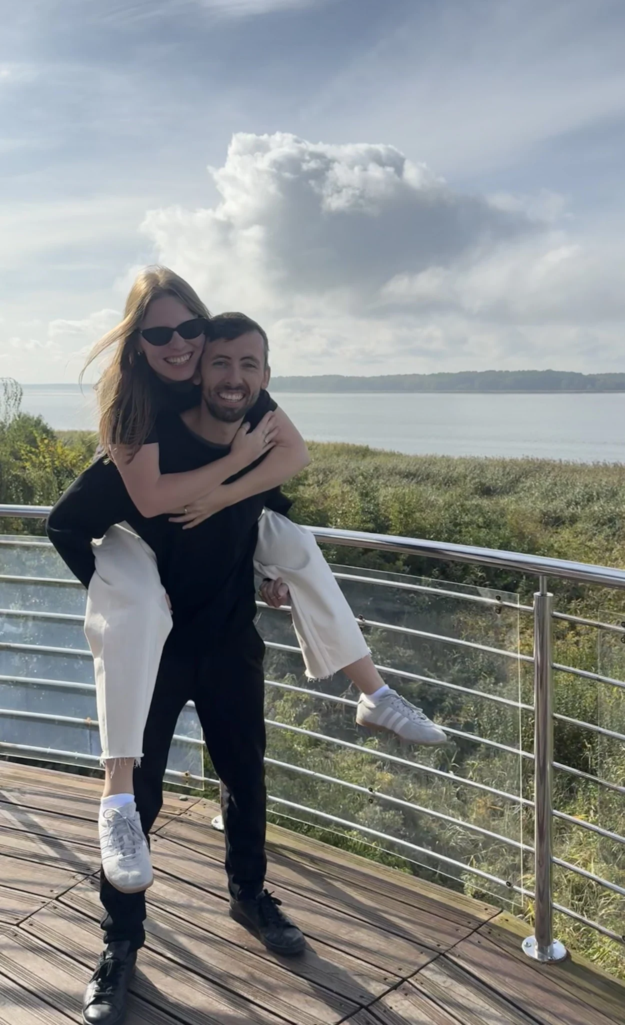 Paulina on Freddie’s back, smiling together by the water